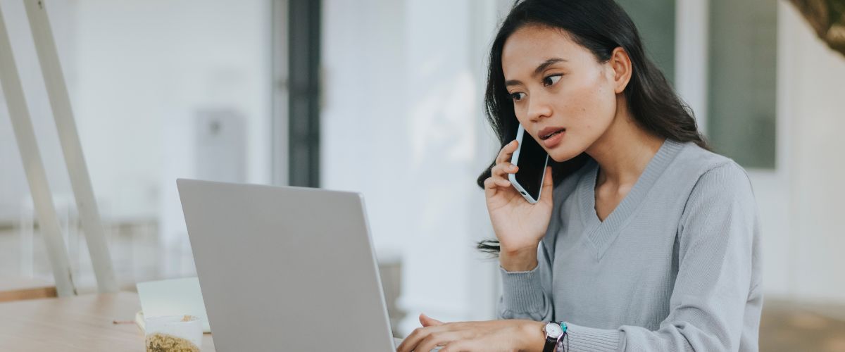 Woman on phone call while working